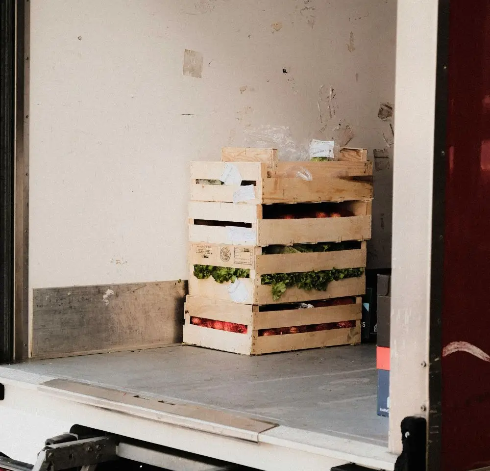 crates of groceries in the back of van